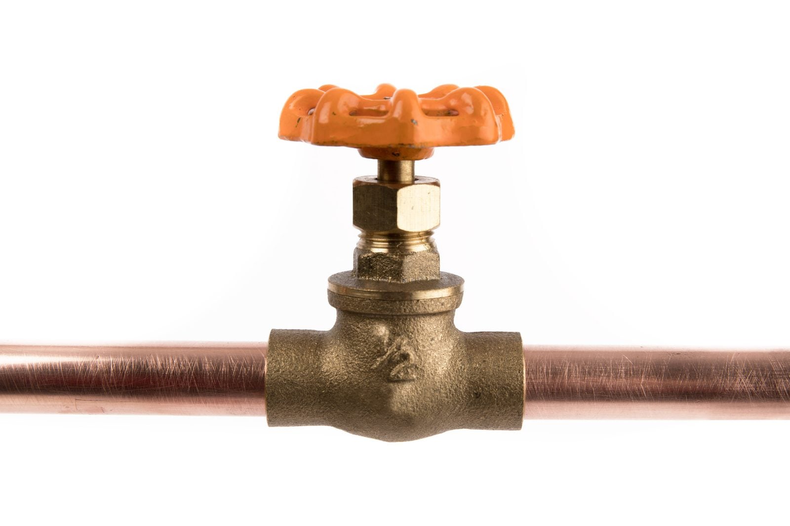 Brass shutoff valve installed on a copper water pipe